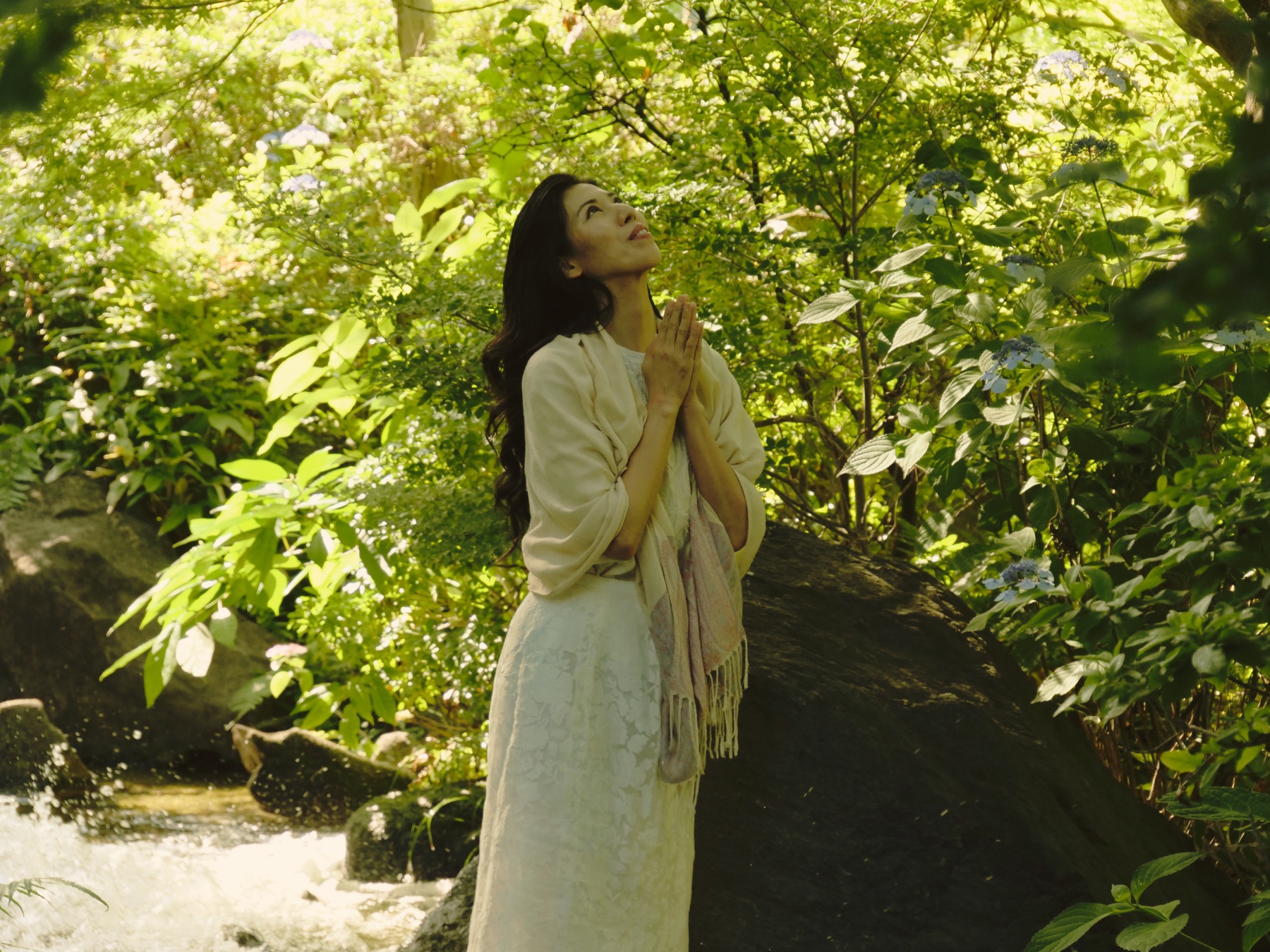 Setsuko Hata beside a mountain stream
