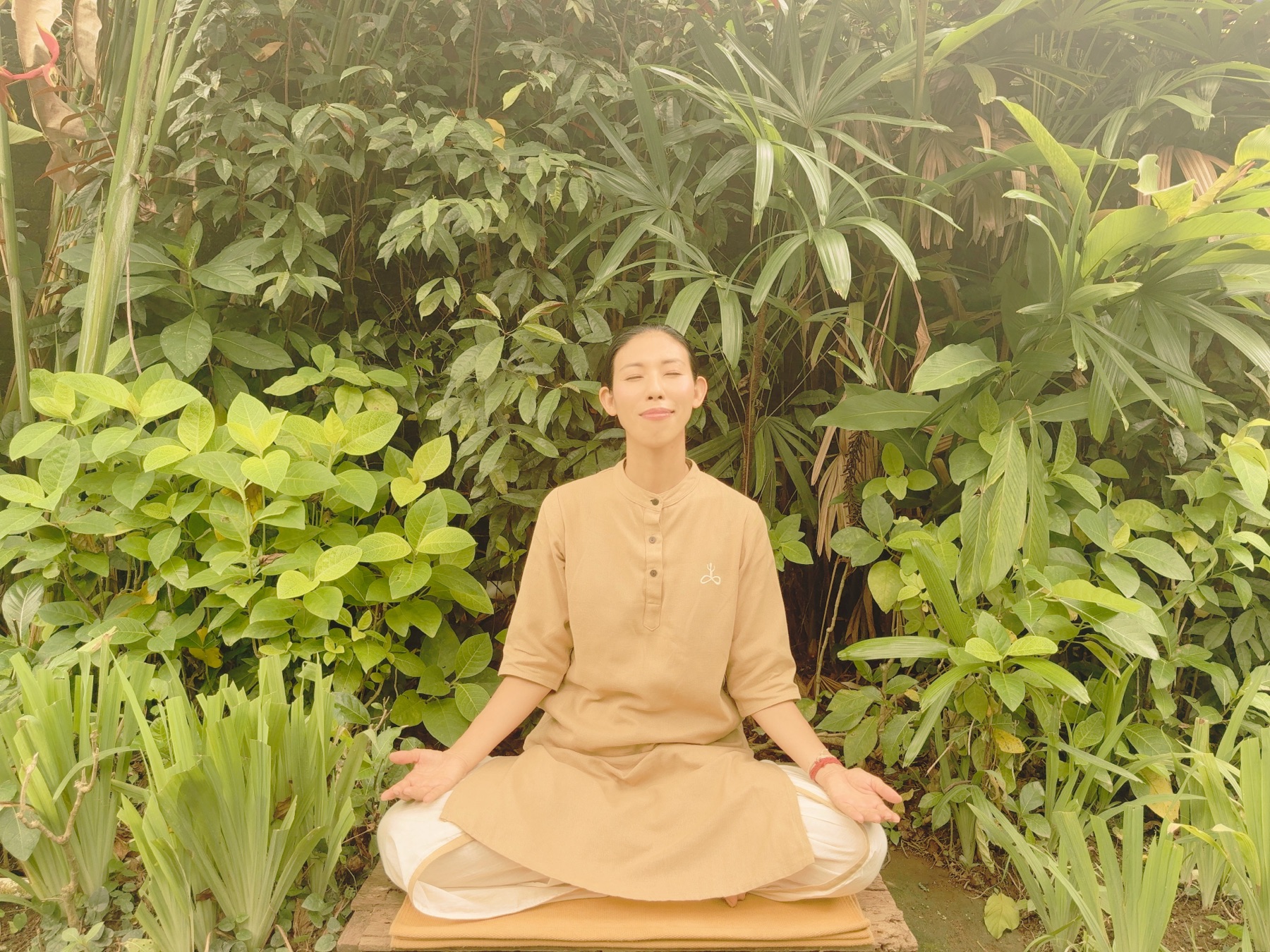 Setsuko Hata meditating in a garden